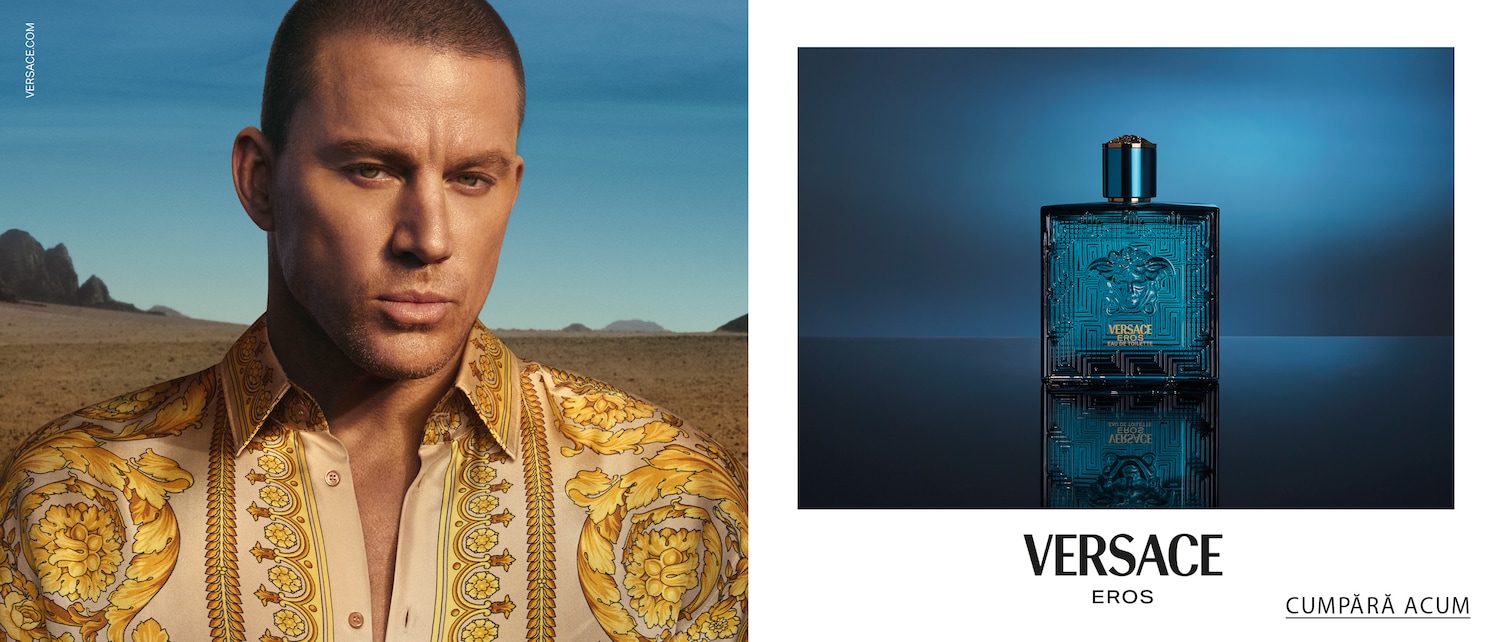 Channing Tatum poartă o cămașă aurie cu model, având un fundal de deșert, cu cer albastru și munți, promovând Versace Eros.